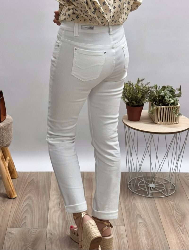 jean blanc femme anna montana coupe ajustée, porté avec une blouse imprimée beige et des sandales compensées.