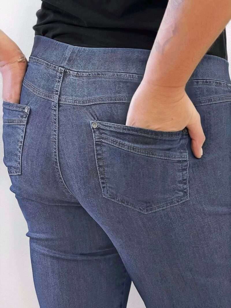 Découvrez le jean Anna Montana Angelika Jump In Slim Fit, le modèle plébiscité qui redéfinit le confort. Il possède l'apparence authentique d'un jean classique en denim bleu foncée, mais offre la souplesse et l'aisance d'un pantalon de détente. Il est parfaitement pensé pour les femmes de 50 ans et plus qui recherchent un jean à la fois moderne et d'un confort absolu au quotidien. Pourquoi l'Angelika Jump In est l'incontournable de votre dressing : L'Effet "Jump In" : La Révolution du Confort C'est l'innovation qui change tout : ce jean s'enfile sans effort grâce à sa conception "pull-on". Pas de fermeture éclair, pas de bouton à l'avant ! Il suffit de l'enfiler pour se sentir immédiatement à l'aise. (Voir photos, la taille est lisse et large). La Ceinture "Magic" : Ventre Plat et Maintien Doux La taille est équipée d'une large ceinture élastiquée plate et invisible qui épouse votre ventre sans comprimer ni marquer. Elle procure un maintien parfait et un subtil effet ventre plat, garantissant un bien-être durable toute la journée, même assise. Denim Stretch et Silhouette Slim Fit Confectionné dans un denim stretch de haute qualité, ce jean est incroyablement souple. Il suit tous vos mouvements tout en conservant la coupe Slim Fit (ajustée sans être moulante). Cette coupe flatteuse affine la jambe et assure une silhouette moderne sans sacrifier l'aisance. Détails Authentiques Malgré l'absence de zip, les détails caractéristiques d'un jean sont présents : fausses poches cavalières sur le devant (pour une silhouette lissée) et poches plaquées fonctionnelles à l'arrière (voir photos), avec surpiqûres et rivets discrets. Le denim bleu foncée (brut/foncé) est idéal pour un look chic et polyvalent. Entdecken Sie die Anna Montana Jeans Angelika Jump In Slim Fit, das gefeierte Modell, das Komfort neu definiert. Sie bietet das authentische Aussehen einer klassischen Jeans aus dunkelblauem Denim, jedoch die Weichheit und Bequemlichkeit einer Freizeithose. Sie ist perfekt konzipiert für Frauen ab 50 Jahren, die eine Jeans suchen, die sowohl modern als auch im Alltag absolut bequem ist. Warum die Angelika Jump In ein Garderoben-Highlight ist: Der "Jump In"-Effekt: Die Revolution des Tragekomforts Diese Innovation ändert alles: Diese Jeans lässt sich dank ihres "Pull-on"-Designs mühelos anziehen. Kein Reißverschluss, kein Knopf vorne! Einfach reinschlüpfen und sich sofort wohlfühlen. (Siehe Fotos, der Bund ist glatt und breit.) Der "Magic"-Bund: Flacher Bauch und Sanfter Halt Der Bund ist mit einem breiten, flachen und unsichtbaren Gummizug ausgestattet, der sich perfekt an den Bauch anschmiegt, ohne einzuengen oder Abdrücke zu hinterlassen. Er sorgt für einen idealen Halt und einen dezenten Flacher-Bauch-Effekt, der den ganzen Tag über anhält, auch im Sitzen. Stretch-Denim und Slim Fit Silhouette Hergestellt aus hochwertigem Stretch-Denim, ist diese Jeans unglaublich geschmeidig. Sie macht jede Bewegung mit und behält dabei den Slim Fit Schnitt (figurbetont, aber nicht hauteng). Dieser schmeichelhafte Schnitt streckt das Bein und sorgt für eine moderne Silhouette, ohne auf Bequemlichkeit zu verzichten. Authentische Details Trotz des fehlenden Reißverschlusses sind die typischen Jeans-Details vorhanden: angedeutete Taschen vorne (für eine glattere Silhouette) und funktionale aufgesetzte Taschen hinten (siehe Fotos), mit dezenten Nähten und Nieten. Das dunkelblaue Denim (Raw/Dunkel) ist ideal für einen schicken und vielseitigen Look.